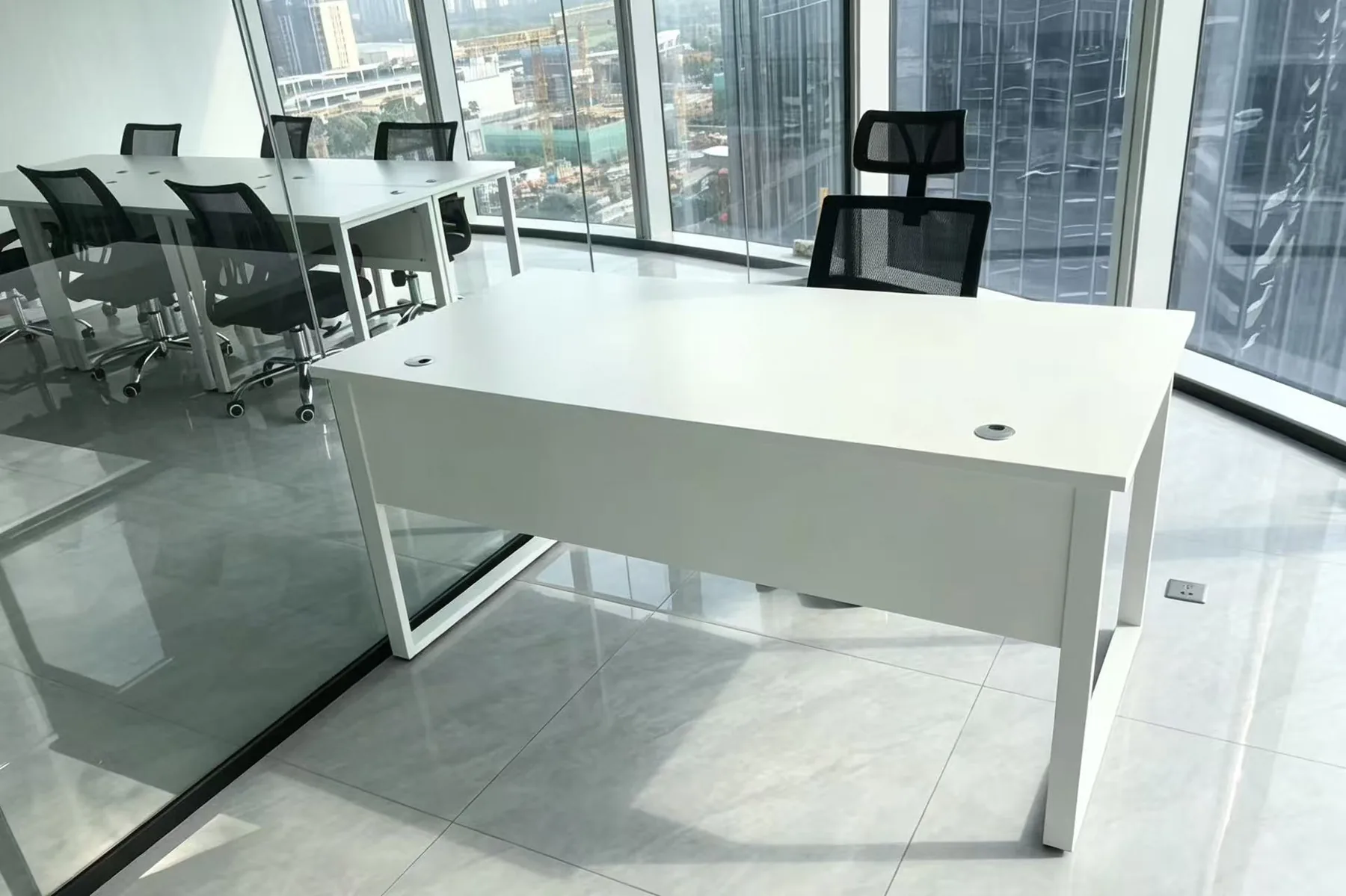 White executive desk in a high-rise office